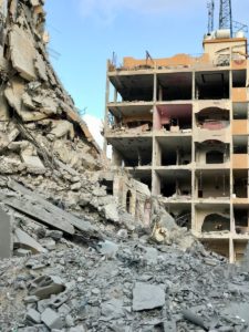 A large building that has a bunch of rubble in front of it
